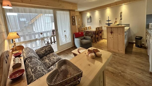 A cozy living room with a sofa, a dining table, and a kitchen area with wooden cabinets and a sink. - Ground floor, tv, 35m², Villard de Lans (Villard-de-Lans)