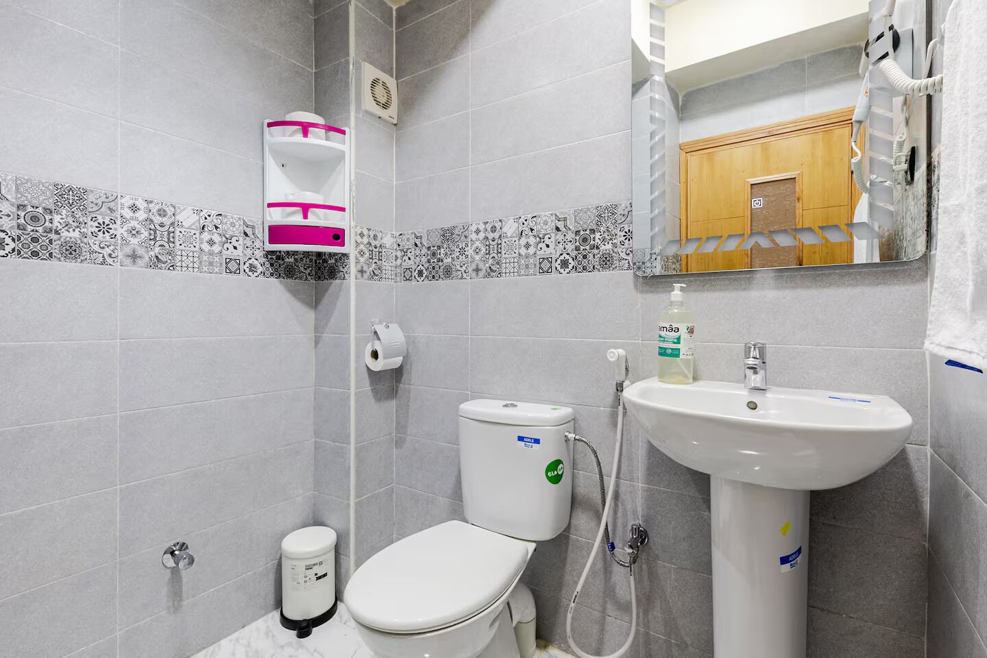 A bathroom with a toilet, sink, and shower.