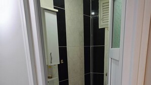 A bathroom with a toilet, sink, and mirror. - Room-standard Twin Bedroom (Istanbul)