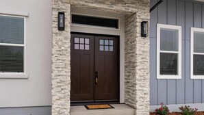 A house with a stone facade, a double door, and two windows with shutters. - Fabulous, brand new 3-bedrm house with views, high-speed internet, AC in Auburn. (Auburn)