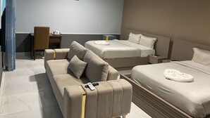 A hotel room with two beds, a sofa, a desk, and an air conditioning unit. - SNL Mountain View Hotel (Akosombo)