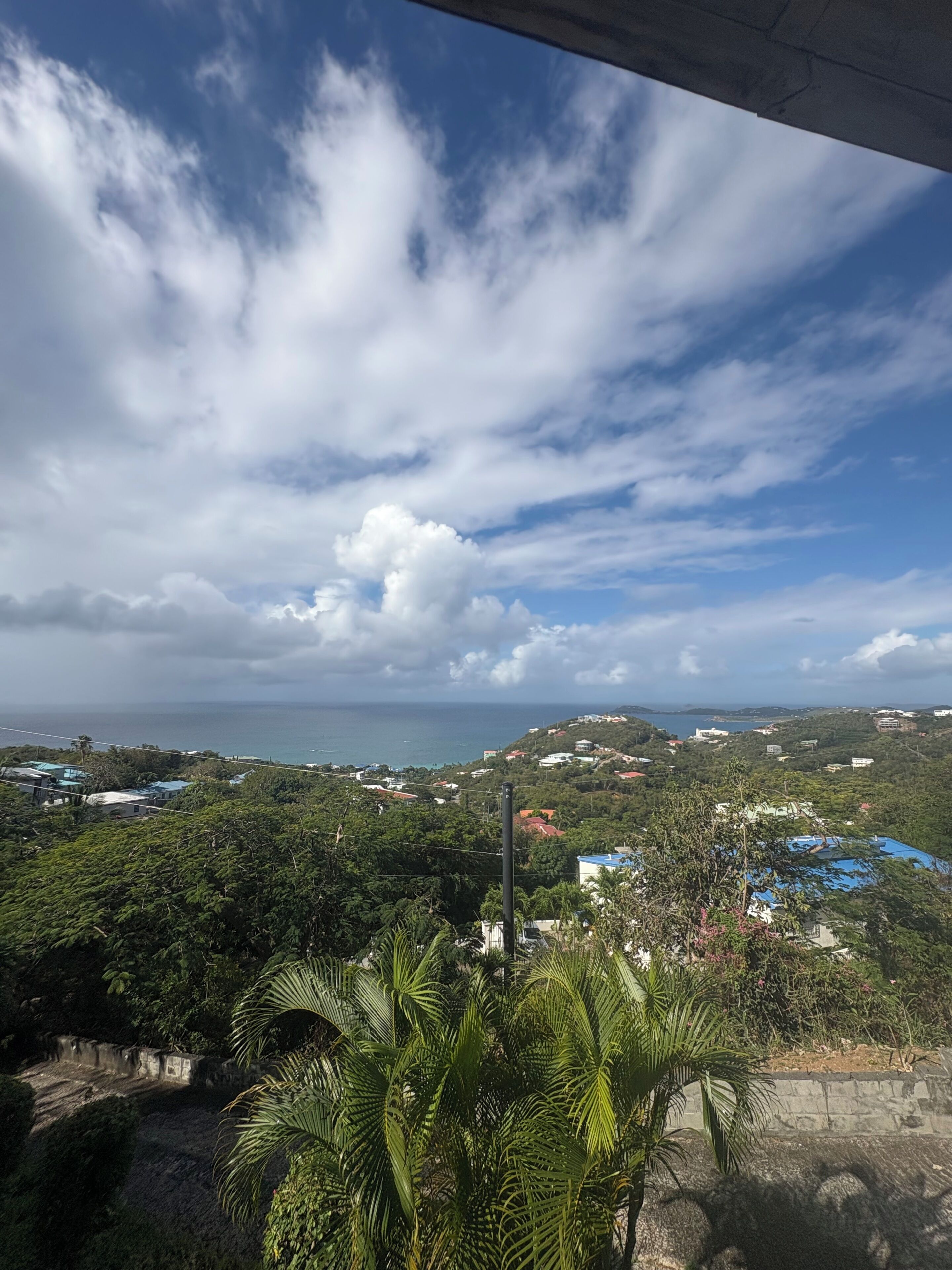 A coastal landscape with a view of the sea and scattered buildings.