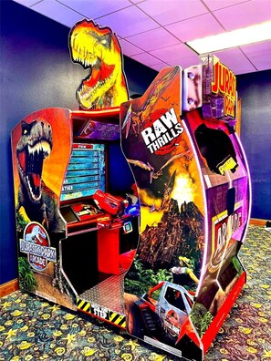 A dinosaur-themed arcade game machine with a control panel and a display screen. - NEW! Paradise Palms | Private Pool | Resort |Upgraded Wifi | Near Attractions (Kissimmee)