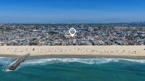An aerial view of a coastal city with a beach, buildings, and a pier. - Perfect Newport Beach Location With Balcony & Spa (Newport Beach)