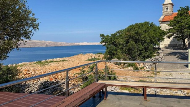 A coastal view with a church, a stone pathway, and a wooden bench. - Americana Karlobag Apartments - One Bedroom Apartment with Terrace (Karlobag)