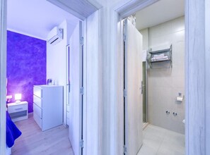 A modern bathroom with a shower, toilet, and a towel rack. - Lumina Sea Apartments Cavtat (Konavle)