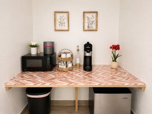 A kitchenette with a microwave, coffee maker, and a trash bin. - 2 Bd Spacious Studio in Clearwater with Pool #8 (Clearwater)