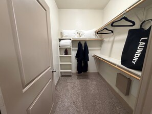 A compact room with a bunk bed, a hanging laundry bag, and a shelf with clothes. - Romantic Luxe Stay, Houston, Texas. (Houston)