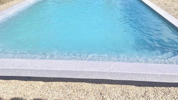 Seasonal outdoor pool, open 10:00 AM to 7:00 PM, pool umbrellas