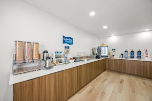 A breakfast bar with cereal, coffee machines, and a sign reading 'Starting Pointe'. - Clarion Pointe Springfield Southeast (Springfield)