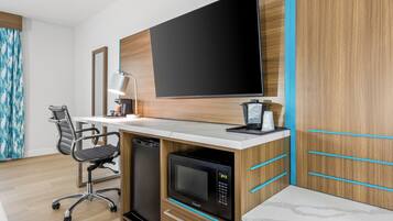 Premium bedding, desk, laptop workspace, blackout drapes