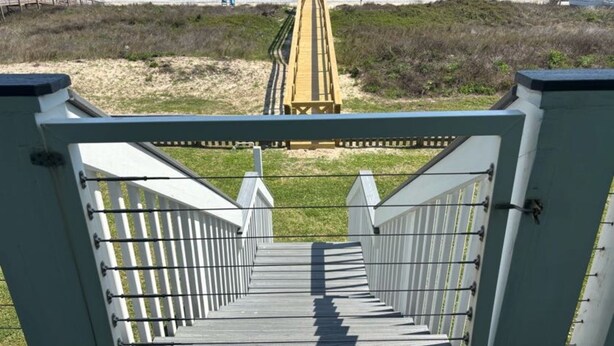 A wooden staircase leading to a beach with a wooden fence and a boardwalk in the background. - Beachfront Escape – Beach Views from Wraparound Porch•Private Walkover W Seating (Freeport)