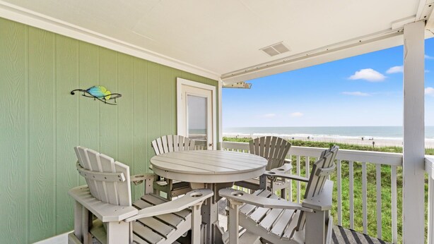 A covered outdoor seating area with a view of the beach. - Coastal Shores - Direct Oceanfront w/ Pool in North Myrtle Beach (North Myrtle Beach)