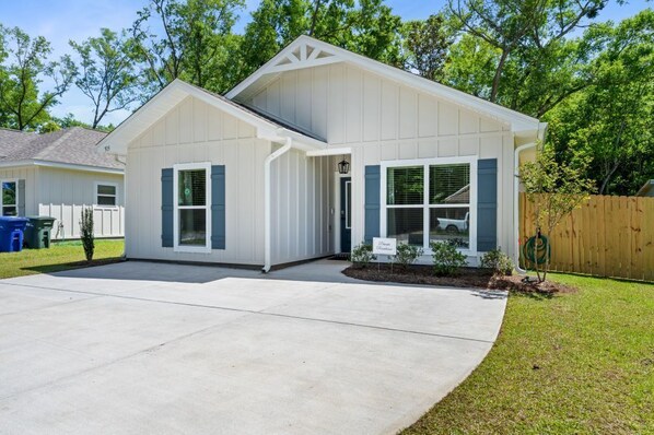 A single-story house with a front porch, a garage, and a small front yard.