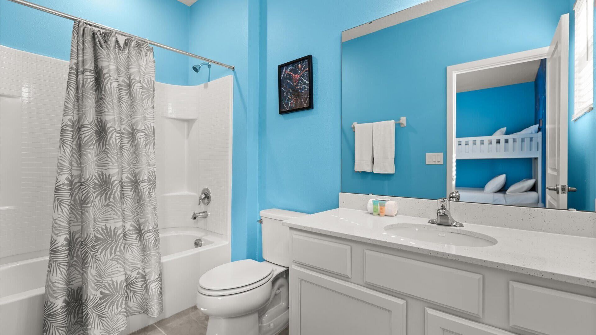 A bathroom with a shower, toilet, and sink.