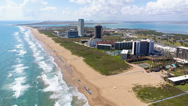 A coastal hotel with beachfront access, high-rise buildings, and a golf course. - Wake Up to Ocean Views - Beachfront Balcony, Pool (South Padre Island)