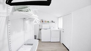 A compact, modern room with a bunk bed, a washing machine, and a dryer. -     Cozy Atlanta Stay Sleeps 4 Near ATL. Free Wifi + Self check in (College Park)