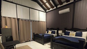 A bedroom with two beds, a desk, a chair, and a large window with curtains. - Alpina Montecarlo (Copán Ruinas)