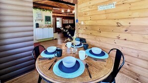 A wooden interior with a dining table set for four, a coffee station, and a sign indicating fresh produce and dairy. - 20 Mins To Hershey Park w/ Farm Animals & Firepit! (Grantville)
