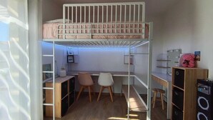 A bunk bed with a desk and chair underneath, a vanity with a mirror and lights, and a small stool. - Family home with private heated pool and air conditioning (Biscarrosse)