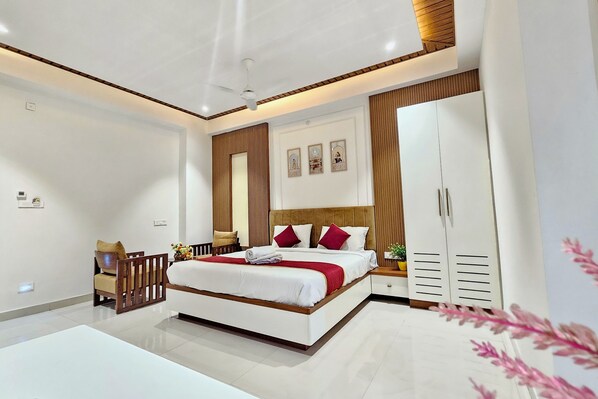 A modern bedroom with a bed, bedside tables, a wardrobe, and a ceiling fan.