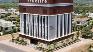 A modern building with a sign reading 'truelife' and 'true suites'. - TrueLife SRB Suites (Tirupati)