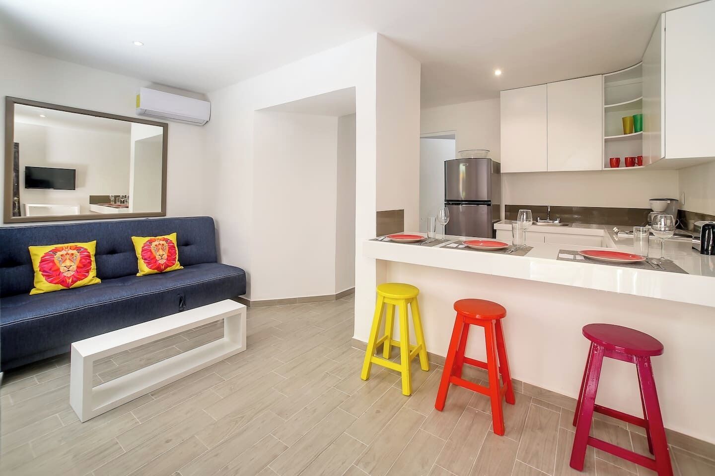 A modern apartment with a living area, a kitchen, and a dining space.