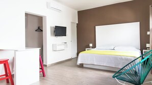 A bedroom with a bed, a TV, a desk, and a chair. - 2nd Floor Studio, King Bed, Kitchen, Rooftop, V17 (Playa del Carmen - Valentina Suites)