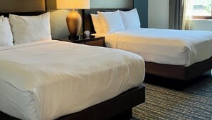 A hotel room with two beds, a nightstand with a lamp, and a view of the outdoors. - Club Wyndham Park City--2BR Deluxe-- Fireplace - (Park City)