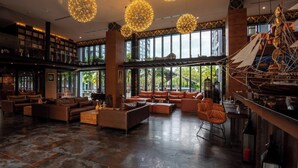 A spacious lobby with modern furniture, large windows, and decorative spherical chandeliers. - Modern 1-bedroom Suite With Pool Access in Kamala, Phuket (Kamala)
