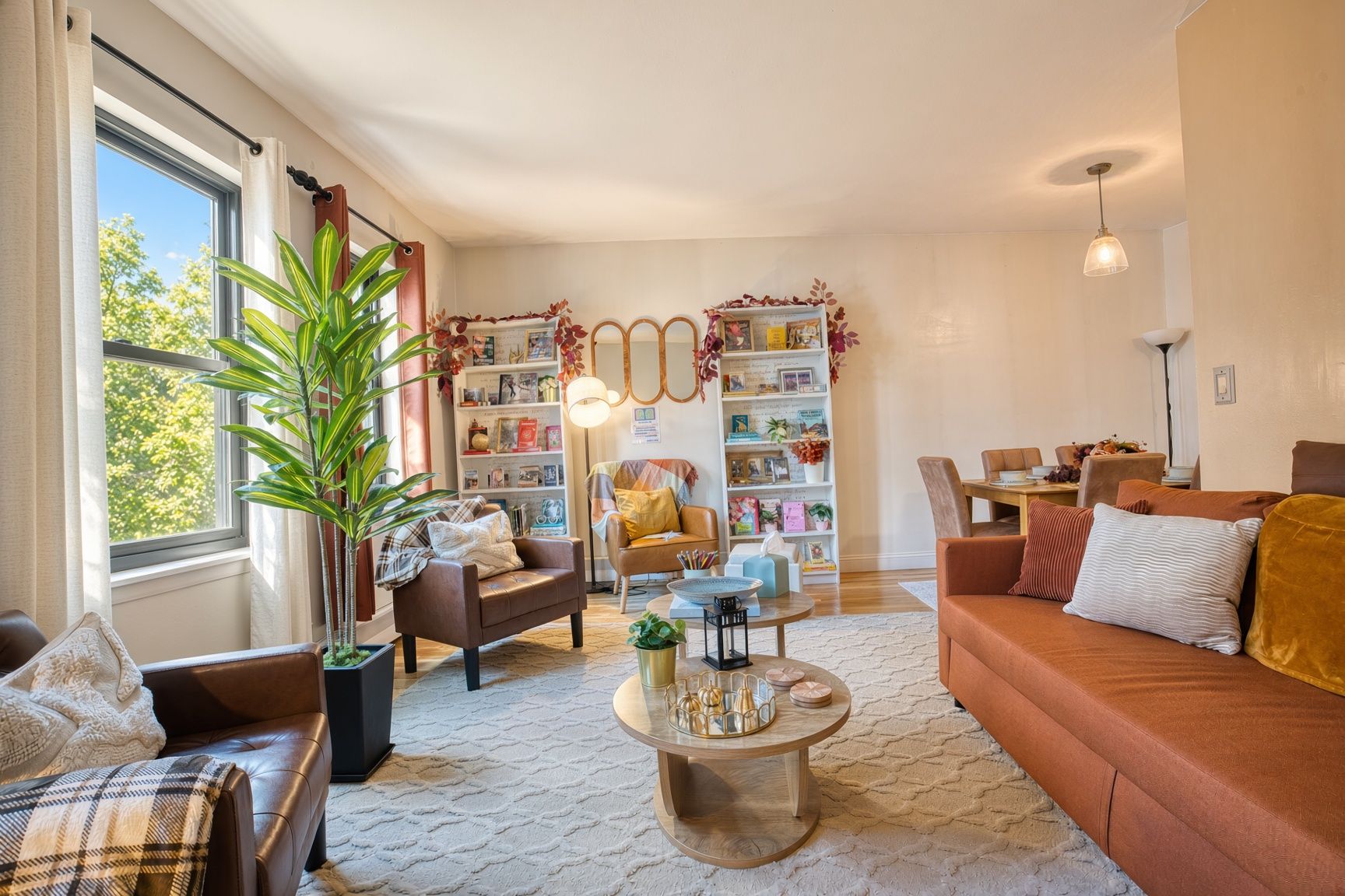 A cozy living room with a fireplace, a bookshelf, and a dining area.