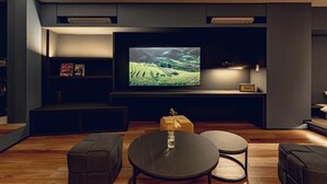 A modern living room with a flat-screen TV, a round coffee table, and two sofas. - craft hotel antenna SHINJUKU KOENJI (Tokyo)