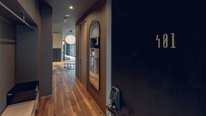 A modern hallway with a wooden floor, a door with the number 401, and a security keypad. - craft hotel antenna SHINJUKU KOENJI (Tokyo)