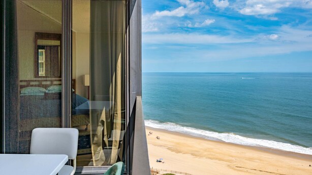 Un balcón con vista al océano y la playa.