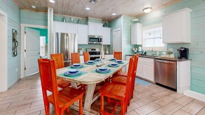 A kitchen with white cabinets, a stainless steel refrigerator, a microwave, and a coffee maker. - SP3 Shared Pool, Pet Friendly, Parking for 3 (Port Aransas)