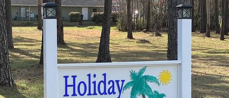 A sign with 'Holiday Haven' and palm tree illustrations.