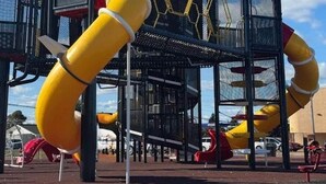 A playground with slides and climbing structures.