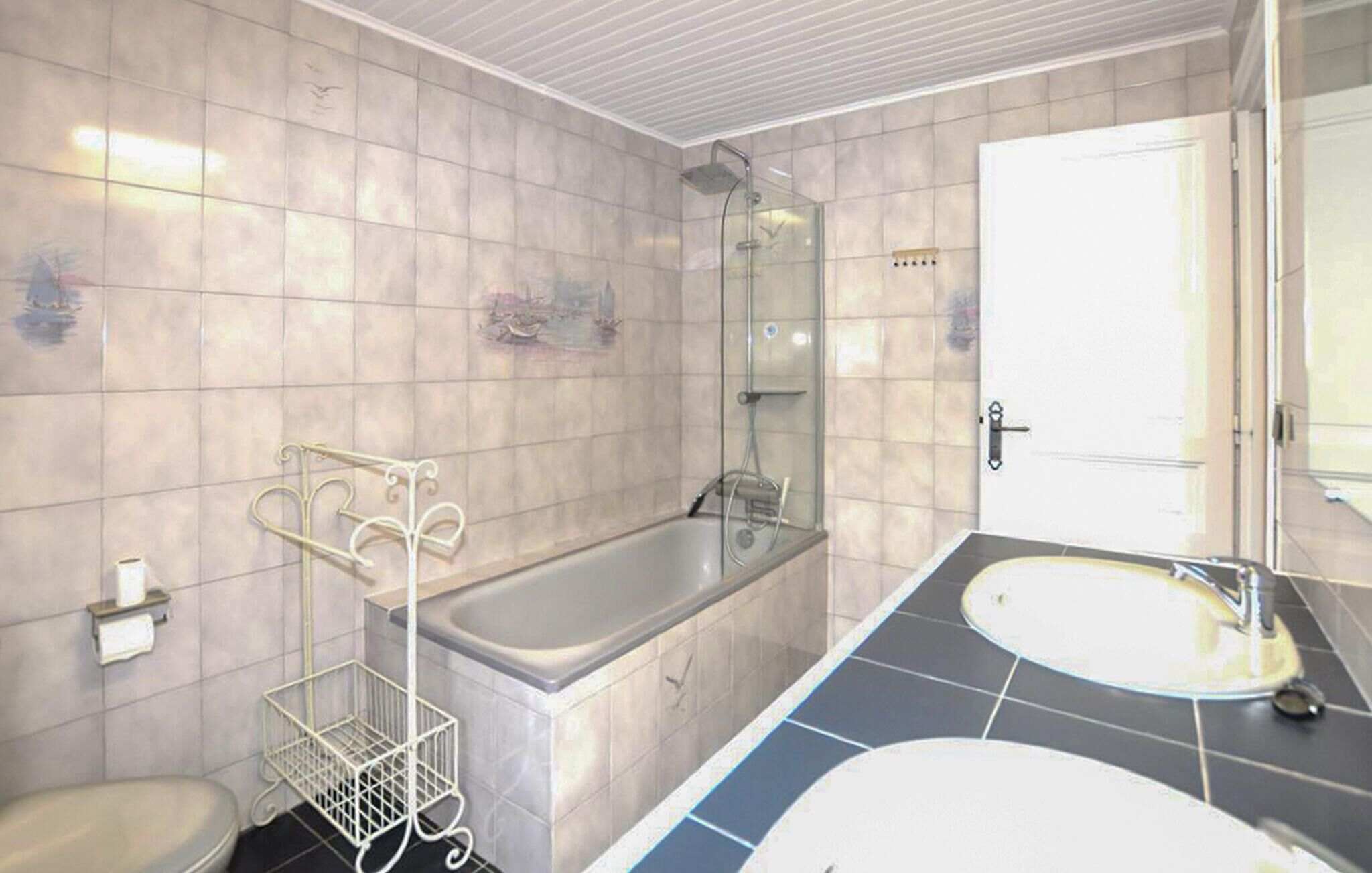 A bathroom with a bathtub, a shower, a toilet, and a sink.