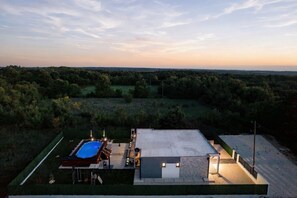 Una propietat residencial amb piscina, terrassa coberta i vistes al paisatge circumdant.