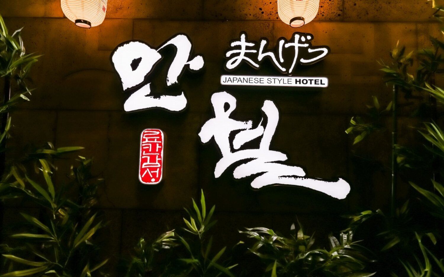 Ein Schild mit japanischen Schriftzeichen und dem Text 'Japanese Style Hotel', das den Stil des Hotels kennzeichnet.