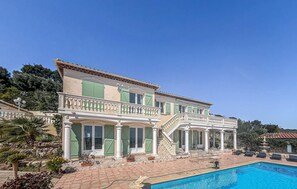 A two-story building with a swimming pool, columns, and a covered patio area. - Awesome home in Cavalaire (Cavalaire)