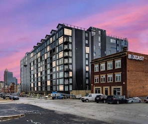 A multi-story building with a modern architectural design, featuring a mix of glass and brick facades.