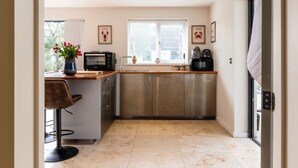 A compact kitchen with a window, a sink, a microwave, and a coffee maker. - Stunning 1 BD Home in Worcestershire (Worcester)