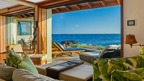 A room with a view of the ocean, a sofa, a table, and lounge chairs. - Honu Kai Villa 1 by Alekona Kauai: Luxury 3BR Oceanfront home with resort amenities (Koloa)