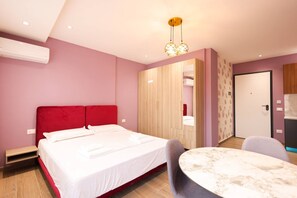 Ein modernes Hotelzimmer mit einem Bett, einem Schreibtisch und einem Stuhl.