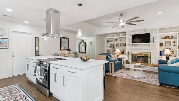 A modern kitchen with white cabinetry, a central island, and a built-in oven. - Pet Friendly Retreat | 3BR w/ Sunroom, Spacious Kitchen + Close to Beach (Saint Simons Island)