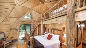 A wooden cabin interior with a loft bedroom, a wooden staircase, and a rustic decor. - Riverfront Home, Private Hot Tub, Go Fish! (Gallatin Gateway)
