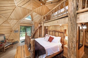 A wooden cabin interior with a loft bedroom, a wooden staircase, and a rustic decor. - Riverfront Home, Private Hot Tub, Go Fish! (Gallatin Gateway)