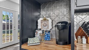 A kitchen with a coffee machine, jars, and a knife block. - Beautiful Meandering Way Retreat (Fort Smith)