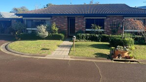 A residential house with a tiled roof, brick walls, a front yard with a pathway, and a mailbox. - Close to beaches, shops with Mikbar 50m towards Springs Beach (Point Lonsdale)